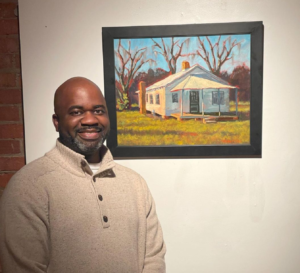 Timothy Joe with one of his rural landscape paintings that he does in addition to birding and nature journaling